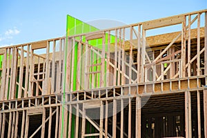 New apartment building under construction on sunny day plywood frame facade