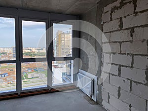 New apartment, new building without finishing and repair, with free planning and walls made of concrete, bricks and gas silicate