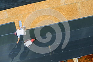 New asphalt bitumen shingles being installed on roof of a residential building