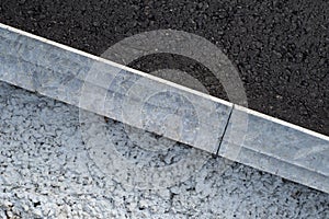 New asphalt road, curbs and of gravel and concrete