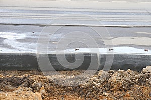 new asphalt road under construction in city, closeup of photo with selective focus