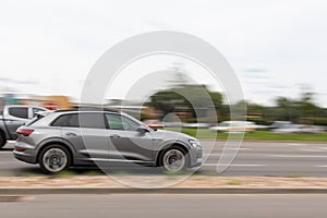 The new Audi E-tron 55 Quattro is driving down the street. Motion blur. Riga, Latvia - 06 Aug 2021