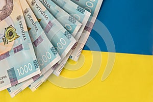 1000 new banknote of Ukraine on yellow blue background. Save and money cocncept