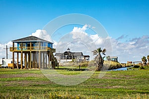 new beach house at Port Bolivar on wooden stilts to protect against flooding, Texas