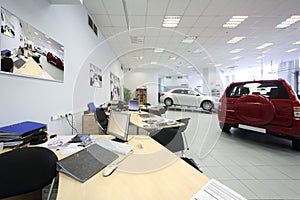 New beautiful cars stand in big office of shop
