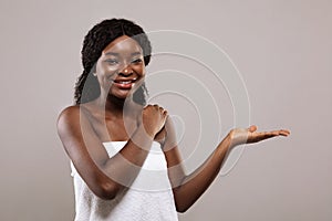 New Beauty Product. African Female Wearing Towel Holding Something On Empty Palm