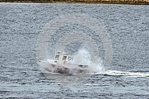 Lobster boat getting some air in choppy water