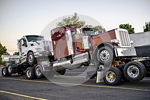 New big rigs semi trucks Trucks are transported in hitch one on top of the other forming a road train