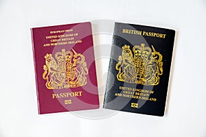 A new black British non European passport with an old red type passport