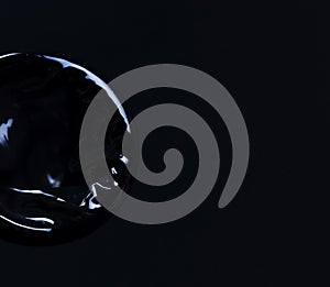 new black condom on a black background