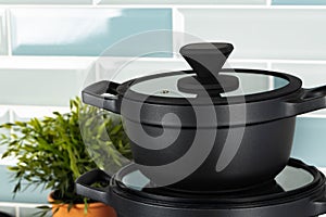 New black cookware against blue tile wall