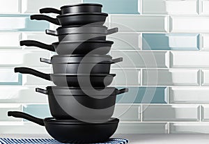 New black cookware against blue tile wall
