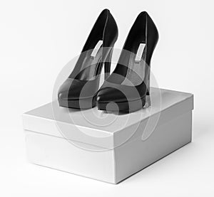 New black leather high heel shoes on the box
