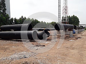 The new black metal pipe for raw water and steam  is overground