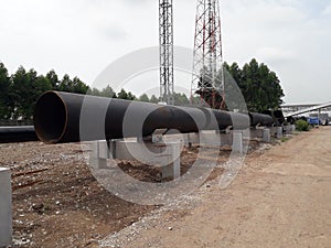The new black metal pipe for raw water and steam is overground