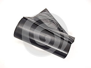 new and black roll of trash bags on white background.