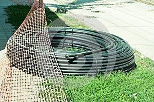 New black rubber industrial water supply hose pipe prepared to be installed .