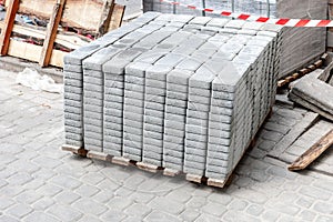 new block paving stack at roadside. paving tiles for road repairs