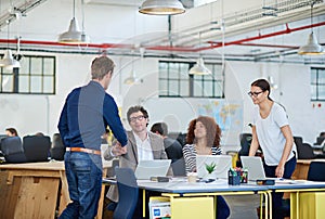 New blood. business people around a table in a large office.