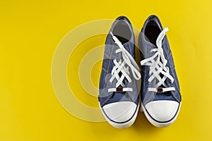 New blue gumshoes on yellow background