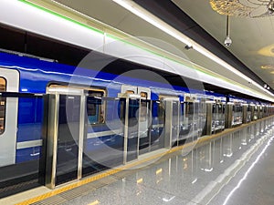 New blue modern subway train high speed fast safe in the big city on the waiting platform at the subway station at the train