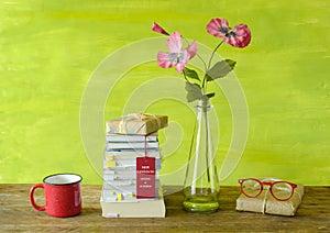 New book, paperback releases for spring 2023, with stack of books, specs,coffee cup and flowers.Spring Book fair, inspiration,