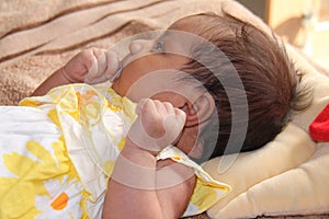 New born asian baby girl thinking