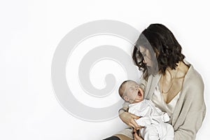 New born baby boy sleeping, yawing on mother`s arm