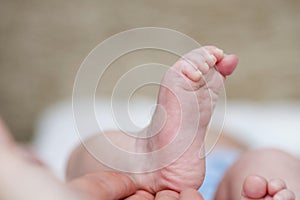 New born baby feet. A close-up of tiny baby feet. Baby feet in hands