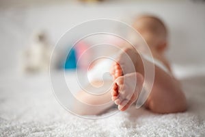 New Born Baby Feet on White Blanket - parenting or love concept.