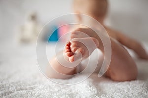 New Born Baby Feet on White Blanket - parenting or love concept.