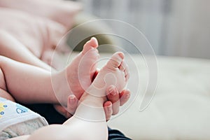 New born baby feet in woman mother hands close up