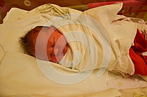 New born baby - girl in a hospital. Newborn baby girl - 3,5 hours old - with warm clothes