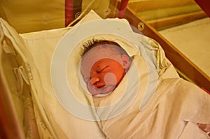 New born baby - girl in a hospital. Newborn baby girl - 3,5 hours old - with warm clothes