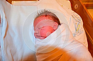 New born baby - girl in a hospital. Newborn baby girl - 3,5 hours old - with warm clothes