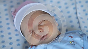 New born baby girl is sleeping in maternity hospital