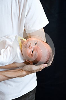 New Born Baby Lying on Father's Arm