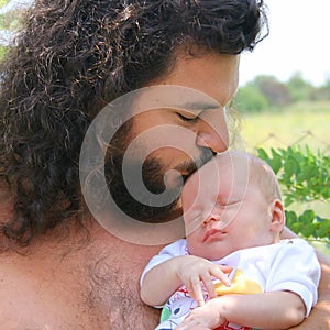 New born baby is sleeping in his father hand