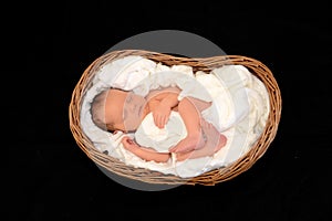 New Born Baby sleeping in a wooden basket