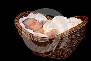 New Born Baby sleeping in a wooden basket