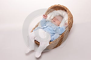 New born baby sleeps in basket