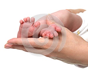New born infant baby feet in mother hands. Mom and Child