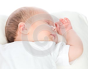 New born infant child baby girl sleeping on a back in white shirt