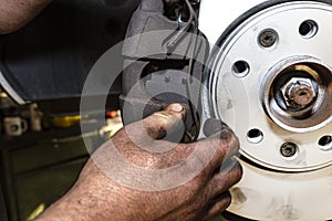 New brake disc with an anti-corrosion layer, mounted on the front hub, installing the brake pads, putting on the spring.