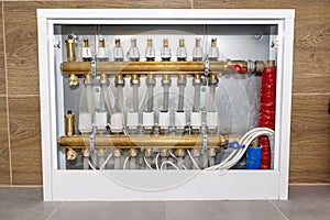 New brass manifold for underfloor heating systems with rotameters and thermoelectric actuators, serving nine circuits.