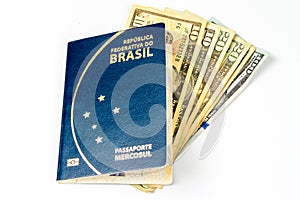 New Brazilian passaport, with some dollar bills in a white background.