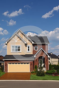 New brick cottage with garage and lawn