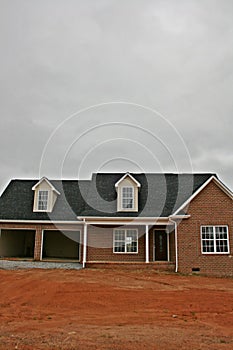 New Brick Home Under Construction - vertical