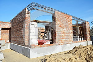 New brick house construction with rebar steel bars, reinforcement concrete bars with wire rod as a lintel for windows and seismic photo