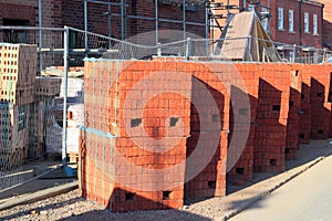 New bricks stacked on a new build site.